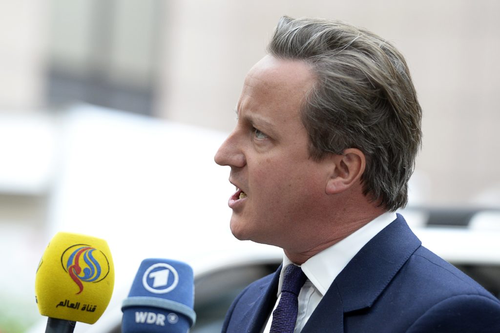 Britain's Prime minister David Cameron talks to journalists as he arrives to attend an European Union (EU) emergency summit on the migration crisis with a focus on strengthening external borders, at the EU Headquarters in Brussels, on September 23, 2015, a day after interior ministers agreed a deal on refugee relocation quotas. AFP PHOTO / THIERRY CHARLIER