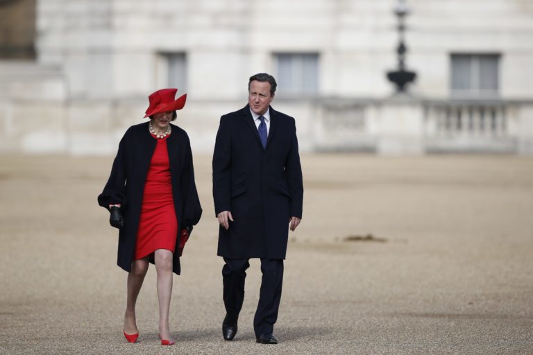 British Prime Minister David Cameron (R) and British Home Secretary Theresa May (L) leave Horse Guards Parade in central London on October 20, 2015 after the ceremonial welcome for Chinese President Xi Jinping and his wife Peng Liyuan on the first official day of a state visit. Chinese President Xi Jinping arrived for a four-day state visit as the government of Prime Minister David Cameron seeks stronger trade ties with the world's second-largest economy. AFP PHOTO / ADRIAN DENNIS / AFP PHOTO / ADRIAN DENNIS