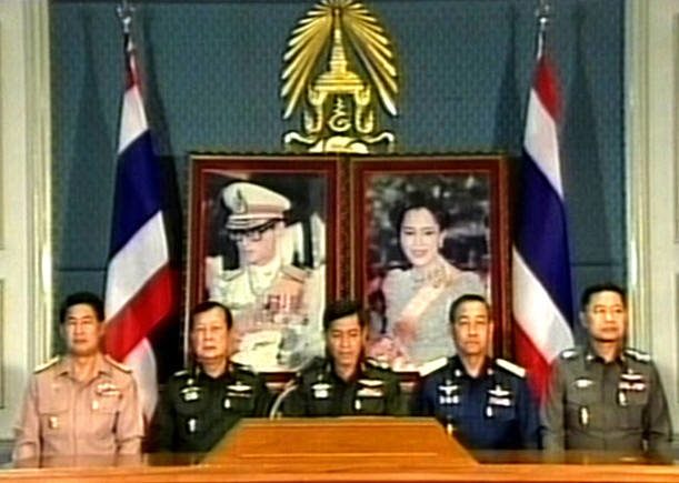 TV grab from Chanel 5 shows Thailand's coup leader, General Sonthi Boonyaratglin (C) speaking during the annoucement of military coup at the army headquarters in Bangkok, 20 September 2006. Thailand's armed forces have seized power from Prime Minister Thaksin Shinawatra in a late-night bloodless coup, revoking the constitution and imposing martial law after months of political turmoil. AFP PHOTO / AFP PHOTO / chanel five / STR