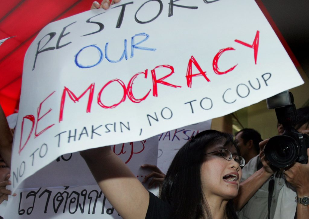 A Thai student shouts slogans for democracy during a protest against the country's coup leaders in front of a shopping mall in Bangkok, 22 September 2006. The group of Thai students and democracy activists protested against the late 19 September military's bloodless coup against prime minister Thaksin Shinawatra, defying the junta's ban on political rallies. AFP PHOTO / MIKE CLARKE / AFP PHOTO / MIKE CLARKE