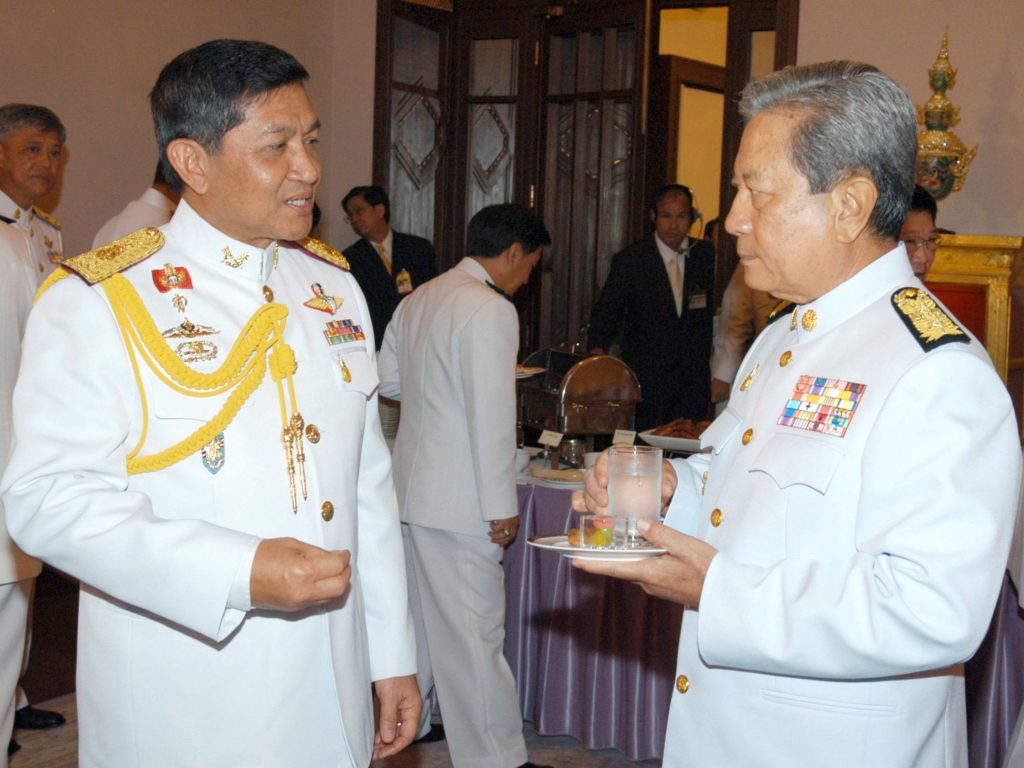 This handout photo released from the Thai Goverment House, new Thai Interim Prime Minister Surayud Chulanont (R) listens to Thai coup leader General Sondhi Boonyaratkalin (L) at the Government House in Bangkok, 01 October 2006. Thailand's new military-appointed premier got down to work 02 October, tasked with healing deep political divisions and assuring the world the country is on the path back to democracy.       RESTRICTED TO EDITORIAL USE  NO GETTY  AFP PHOTO/GOVERNMENT HOUSE/HO / AFP PHOTO / GOVERNMENT HOUSE / AFP