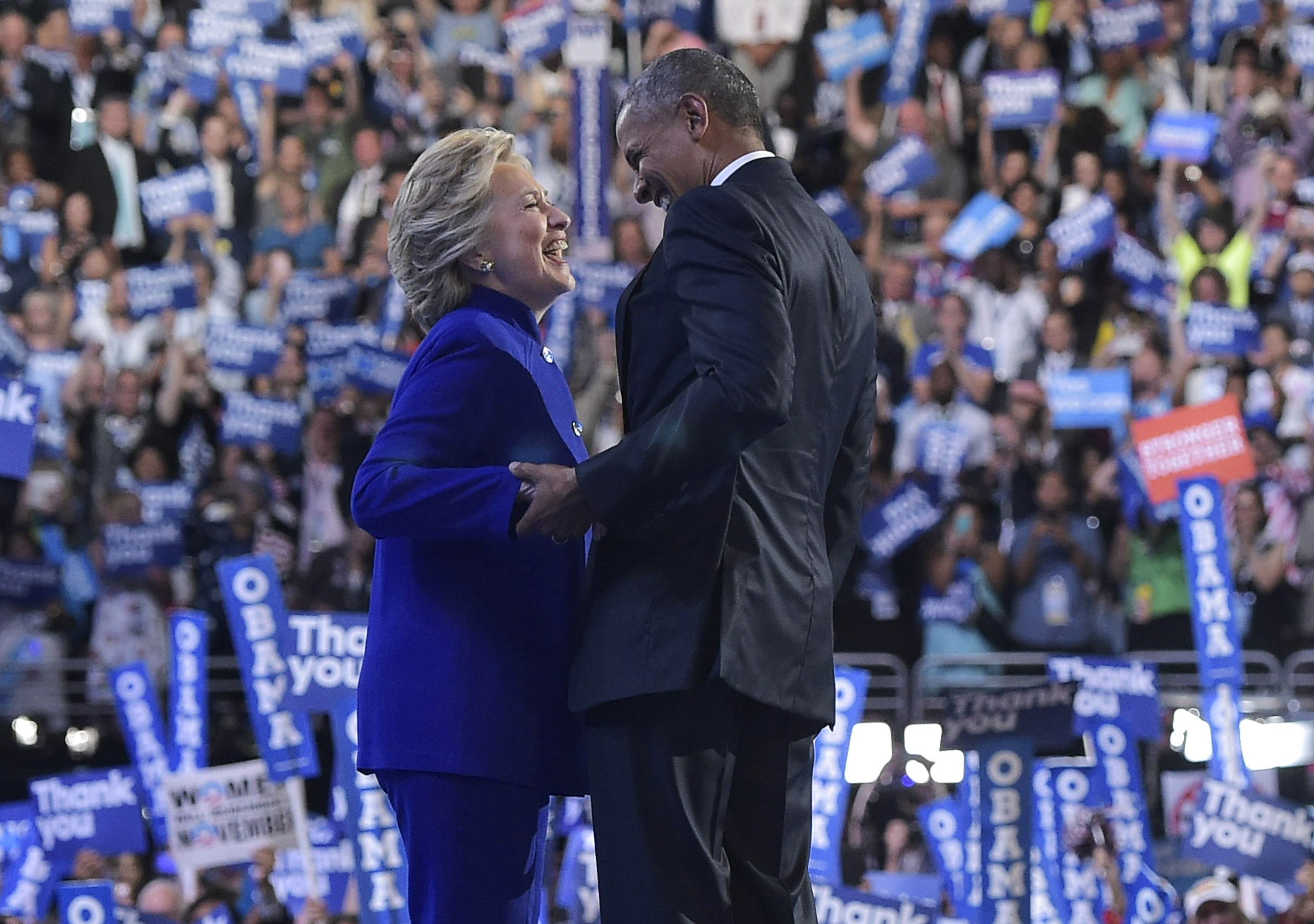 TOPSHOT - US President Barack Obama is joined by US Democratic presidential candidate Hillary Clinton after his address to the Democratic National Convention at the Wells Fargo Center in Philadelphia, Pennsylvania, July 27, 2016. / AFP PHOTO / MANDEL NGAN