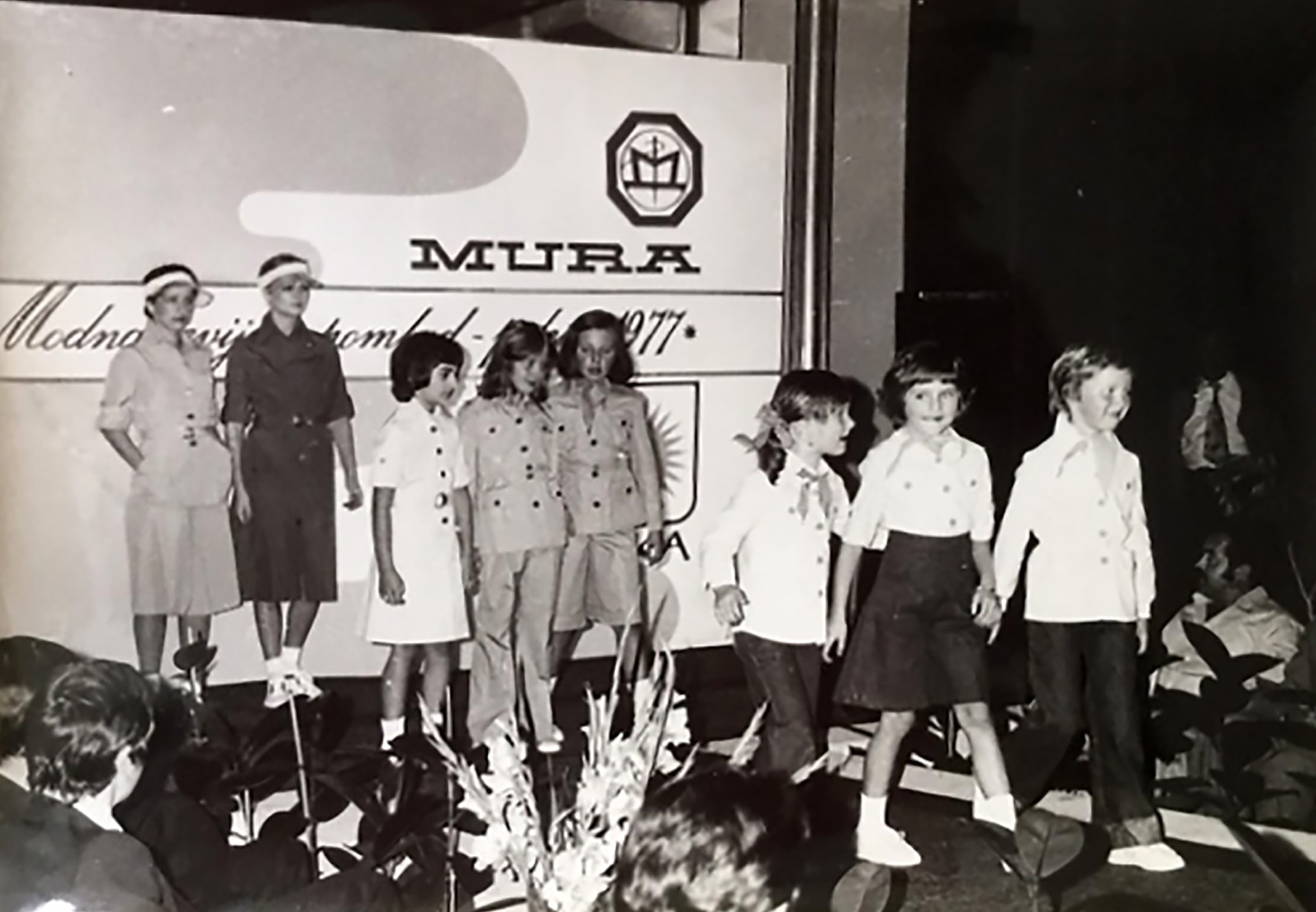 This picture provided by courtesy of Nena Bedek and taken in 1977 in Radenci, northeastern Slovenia, shows Slovenian-American former model and Donald Trump's wife Melania Trump (born Melanija Knavs)(2nd R) as a child, together with Nena Bedek (R), attending a fashion review of Jutranjka, the textile company where her mother used to work. Because of Melania Trump's husband success so far in the Republican race for the White House candidacy, foreign journalists and tourists have become a frequent sight in her birth region, set in rolling hills 100 kilometres (60 miles) from the capital Ljubljana. / AFP PHOTO / Nena Bedek / STR