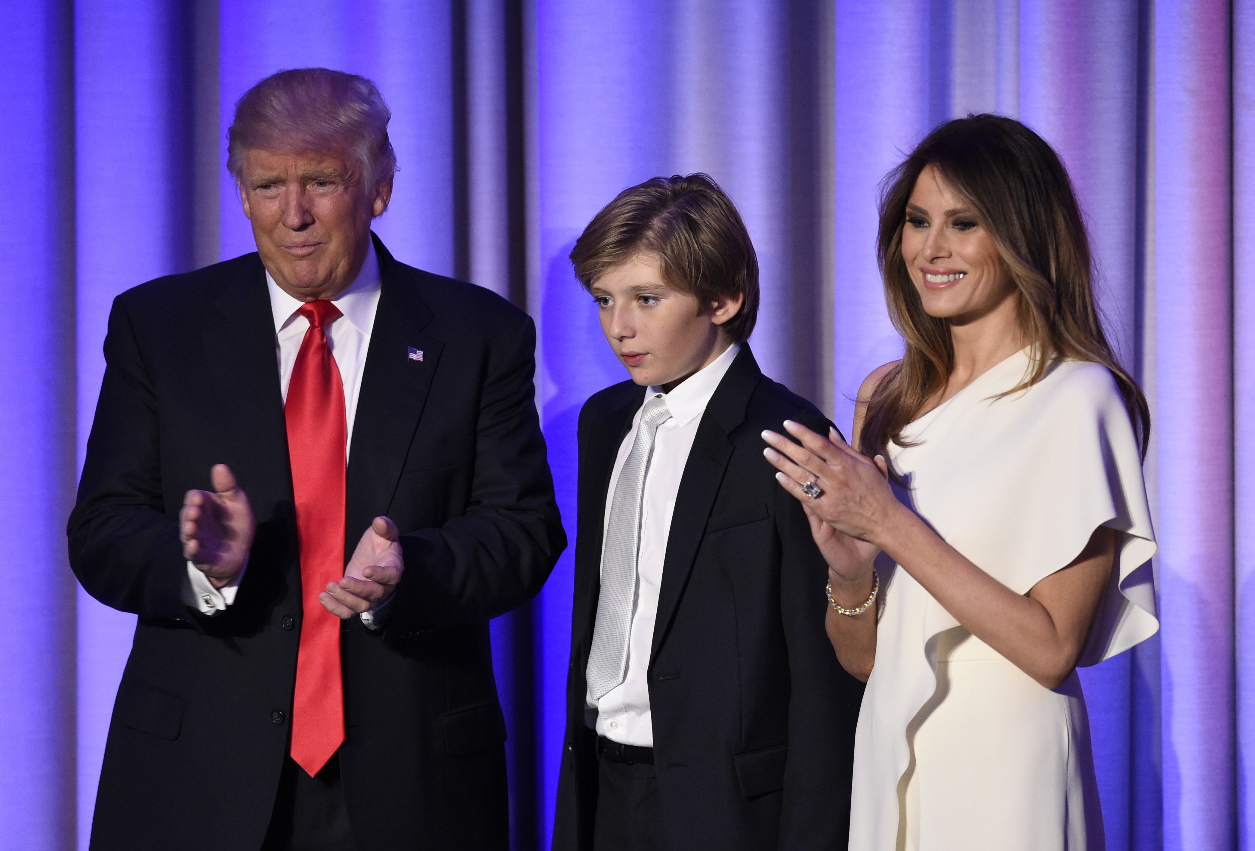 US President-elect Donald Trump arrives with his son Baron and wife Melania at the New York Hilton Midtown in New York on November 8, 2016. Trump stunned America and the world Wednesday, riding a wave of populist resentment to defeat Hillary Clinton in the race to become the 45th president of the United States. / AFP PHOTO / SAUL LOEB