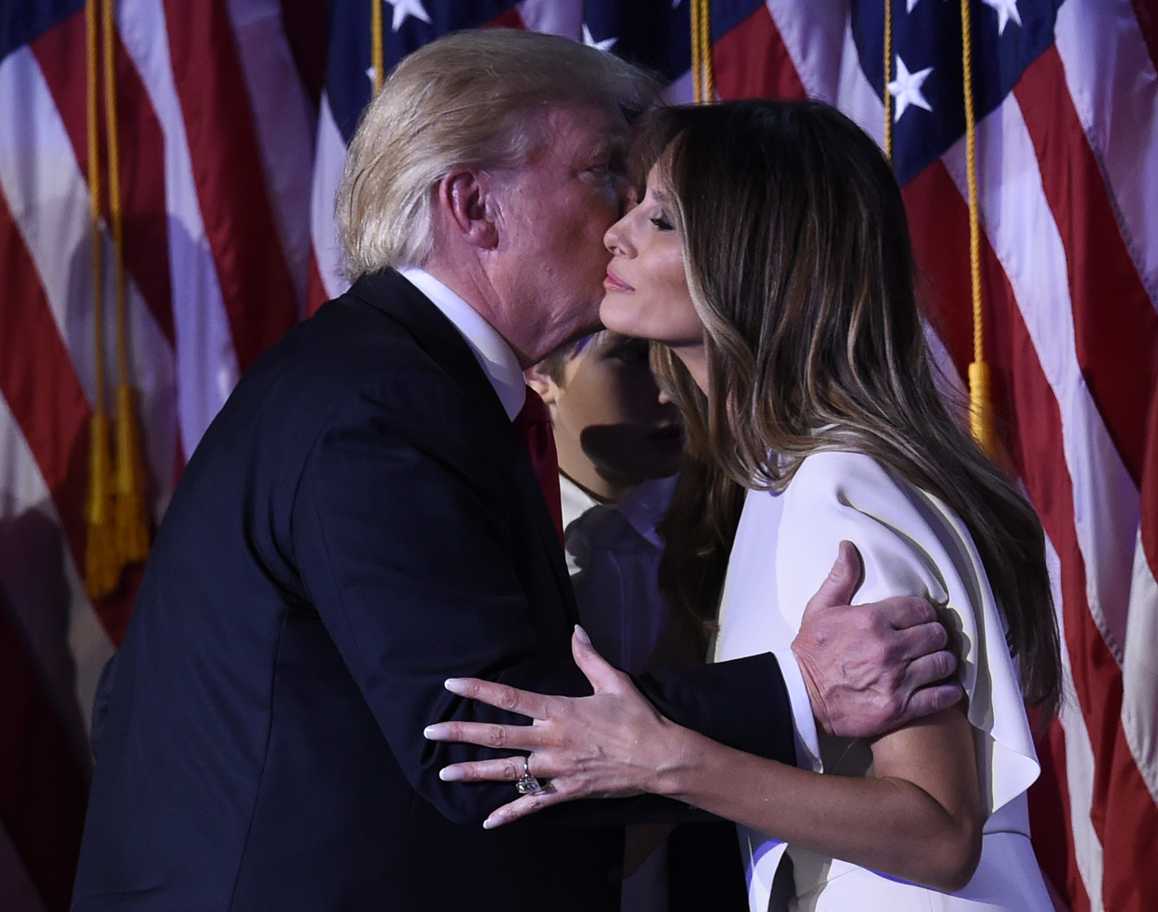 US President-elect Donald Trump greets wife Melania after speaking at the New York Hilton Midtown in New York on November 8, 2016. Trump stunned America and the world Wednesday, riding a wave of populist resentment to defeat Hillary Clinton in the race to become the 45th president of the United States. / AFP PHOTO / SAUL LOEB