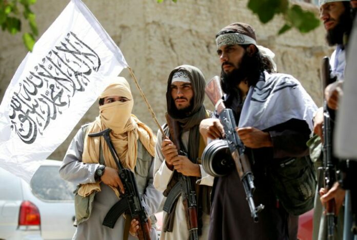 FILE PHOTO: Taliban walk as they celebrate ceasefire in Ghanikhel district of Nangarhar province, Afghanistan
