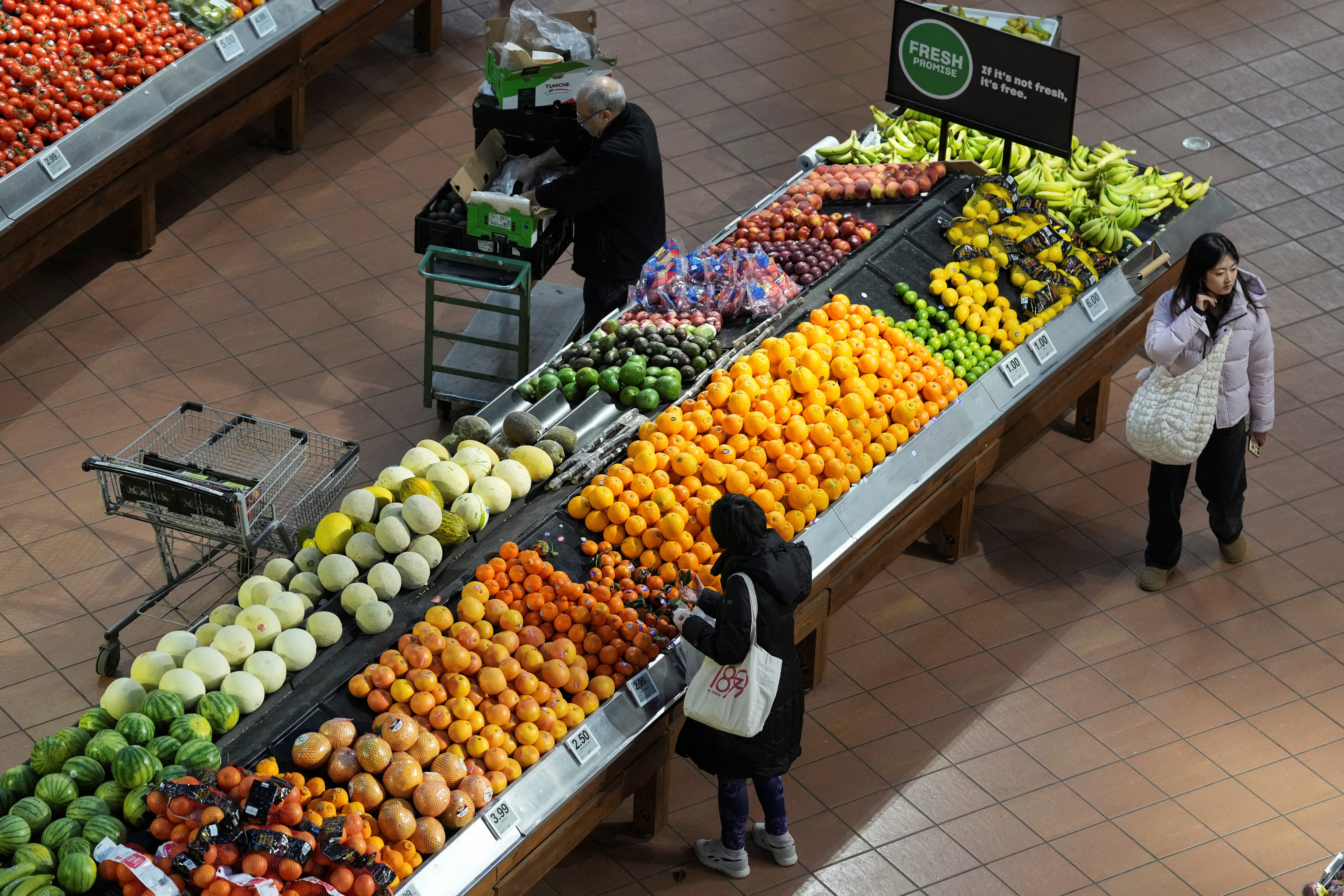 People browse a grocery store after the accnocunment of tariffs on Canadian and Mexican goods by U.S. President Donald Trump